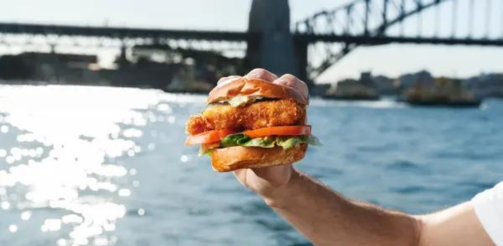 A burger from Opera Bar Sydney with the Harbour Bridge in background