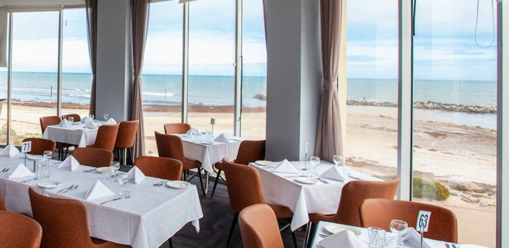The dining room with sweeping ocean and marina views at Sammy's on the Marina