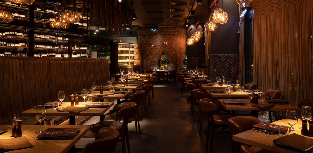 The stunning, dimly lit dining room at The Meat & Wine Co Barangaroo