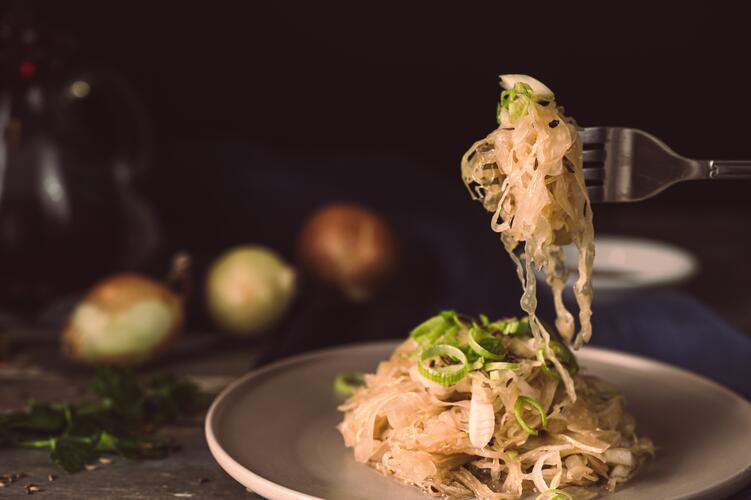 Sauerkraut on a plate and fork: fermented food ready to be enjoyed