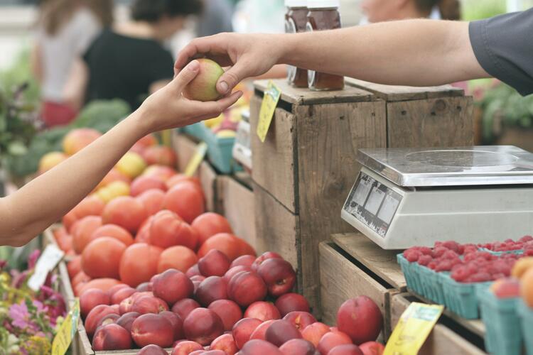 Locally produced food, such as these apples sold at a food stall