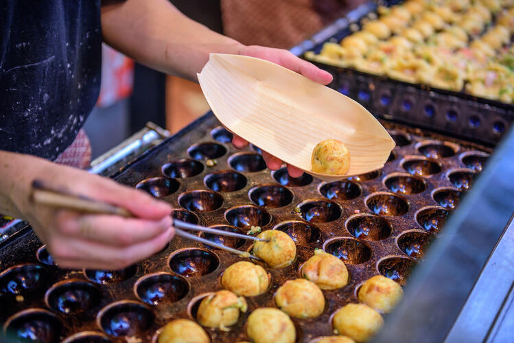 Moulded pan with deep fried Takoyaki, a Japanese street food