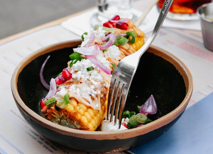 Grilled corn on a skewer at a BBQ restaurant in UK 
