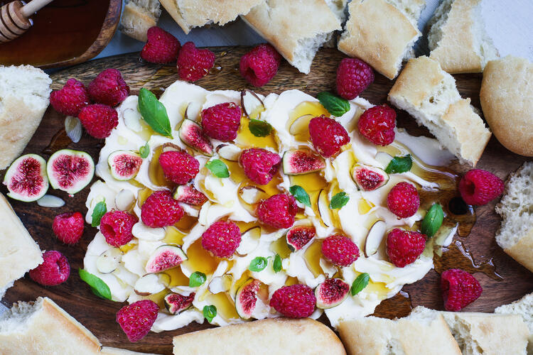 Butter board topped with honey, figs and raspberries