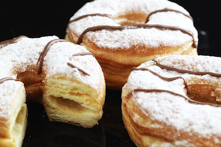  Delicious cronuts sprinkled with icing sugar and chocolate ready to eat