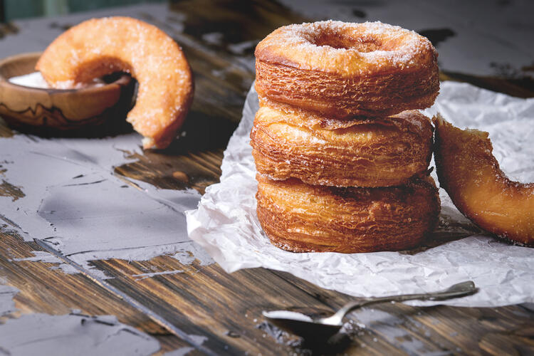 Cronut cut in half with sugar topping