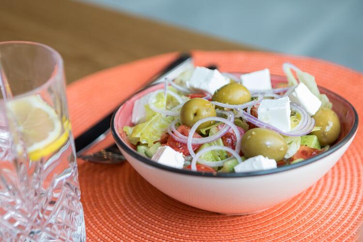 Cheese cubes with olives, onions and tomatoes in a bowl