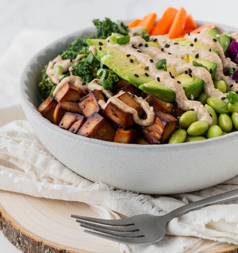 White bowl of fried tofu and chopped vegetables: example of plant-based protein