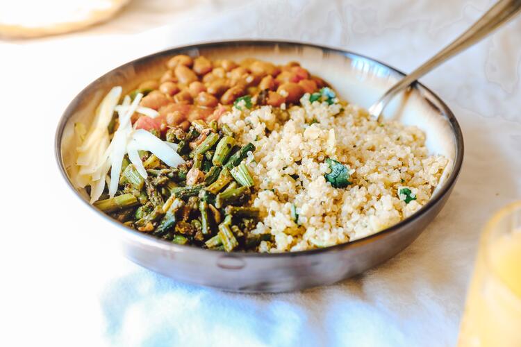 Quinoa, a plant-based protein, with tomato and cucumber in a bowl of tabbouleh