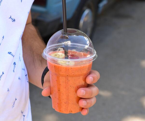 Smoothie in a cup on the go, with banana and berries: part of a smoothie diet