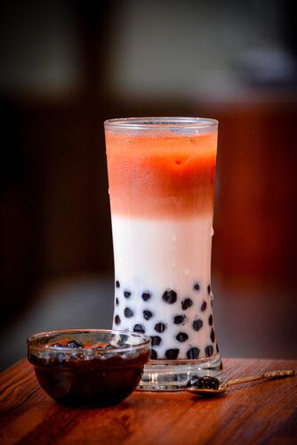 What is bubble tea? Bubble tea served in a bar with bowl of additional pearls