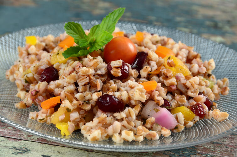 A plate of wheat berries salad with fresh vegetables