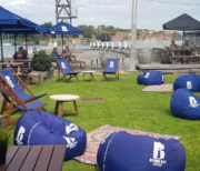 The outdoor lawn and dining area at Marina Bar and Cafe