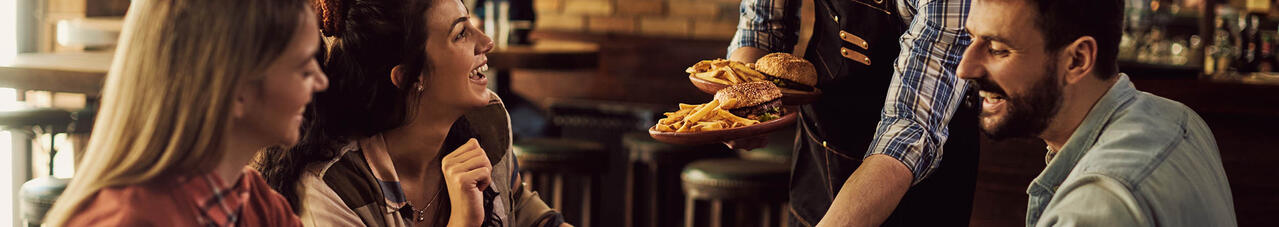 Waiter brings burgers