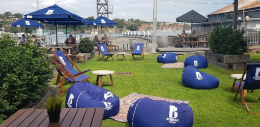 The outdoor lawn and dining area at Marina Bar and Cafe